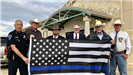 Men Holding Thin Blue Line Flag